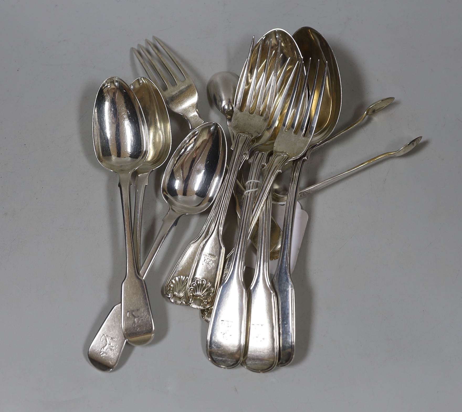 Eleven items of 19th century silver flatware, including a set of three Scottish silver fiddle and thread pattern table spoons, 19.8oz.